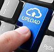 Uploading file. gesture of finger pressing upload button on a computer keyboard representing the link to upload documents.